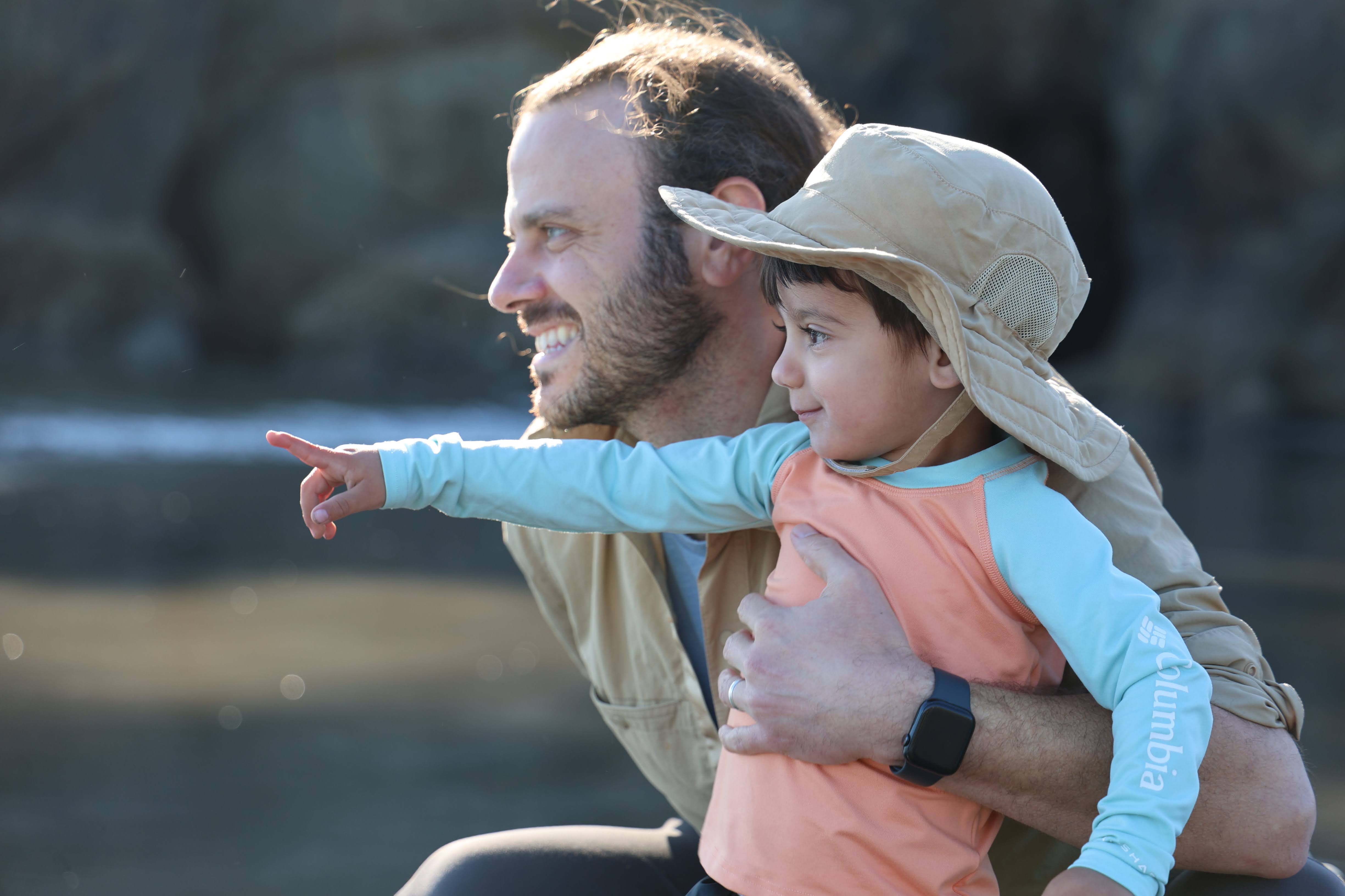 Father and child enjoying the coast together