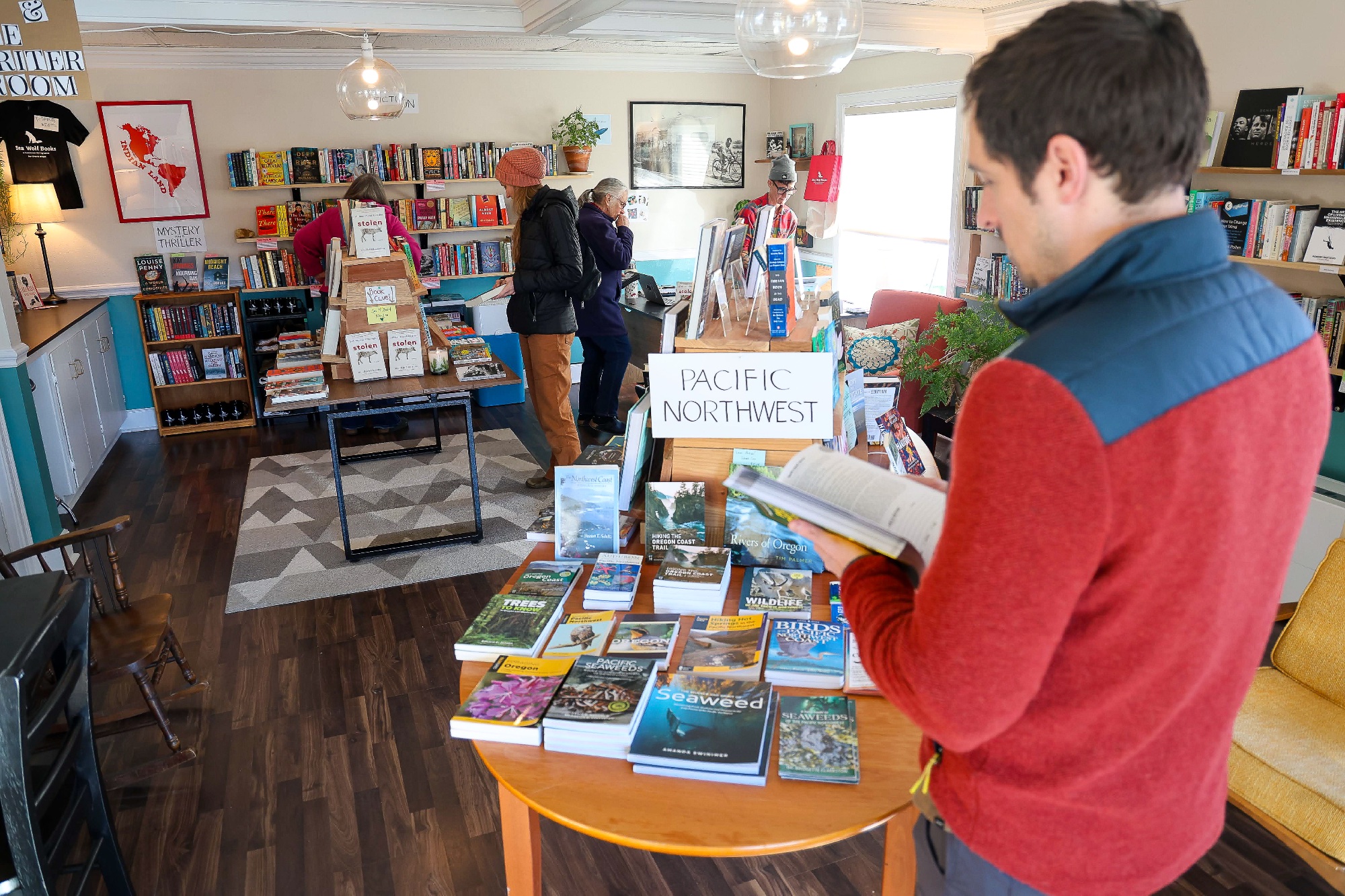 Customers browsing Pacific Northwest books at Sea Wolf Bookstore
